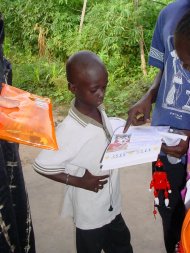 EB, one of the sponsored children, having his sponsor's letter explained