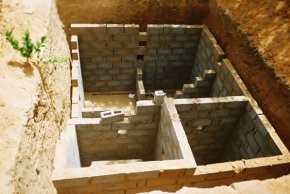 underground effluent chambers being constructed with concrete blocks in a deep pit