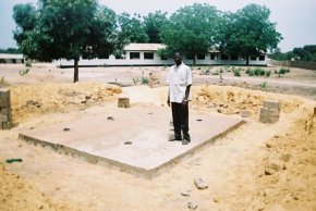 a concrete base slab has been cast over the underground chambers at ground level, with a series of holes for the effluent