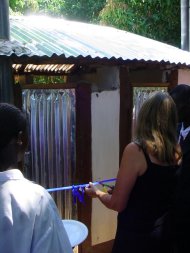 Pippa cuts a ribbon at the door of one of the toilets