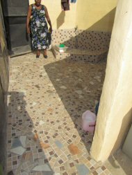 broken tiles used in an area outside the toilets used for babies' potties