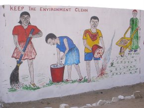 a painting showing pupils clearing up rubbish with the message 'keep the environment clean'