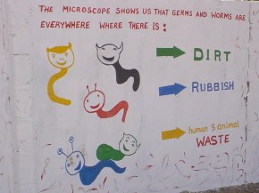 this panel has the message 'The microscope shows us that germs are everywhere where there is dirt, rubbish and human & animal waste