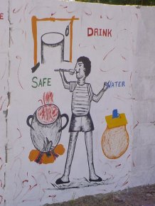 a panel about safe water, showing water coming from a well, being boiled and then covered