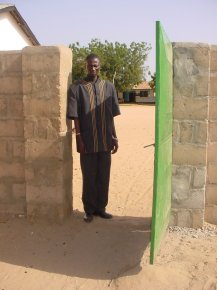 Mr Giteh, the headmaster, stands in one of the gateways in the wall