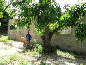 Wandifa beside the shell of his new house