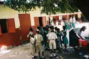 Wesley children being served their meals from a temporary outdoor kitchen